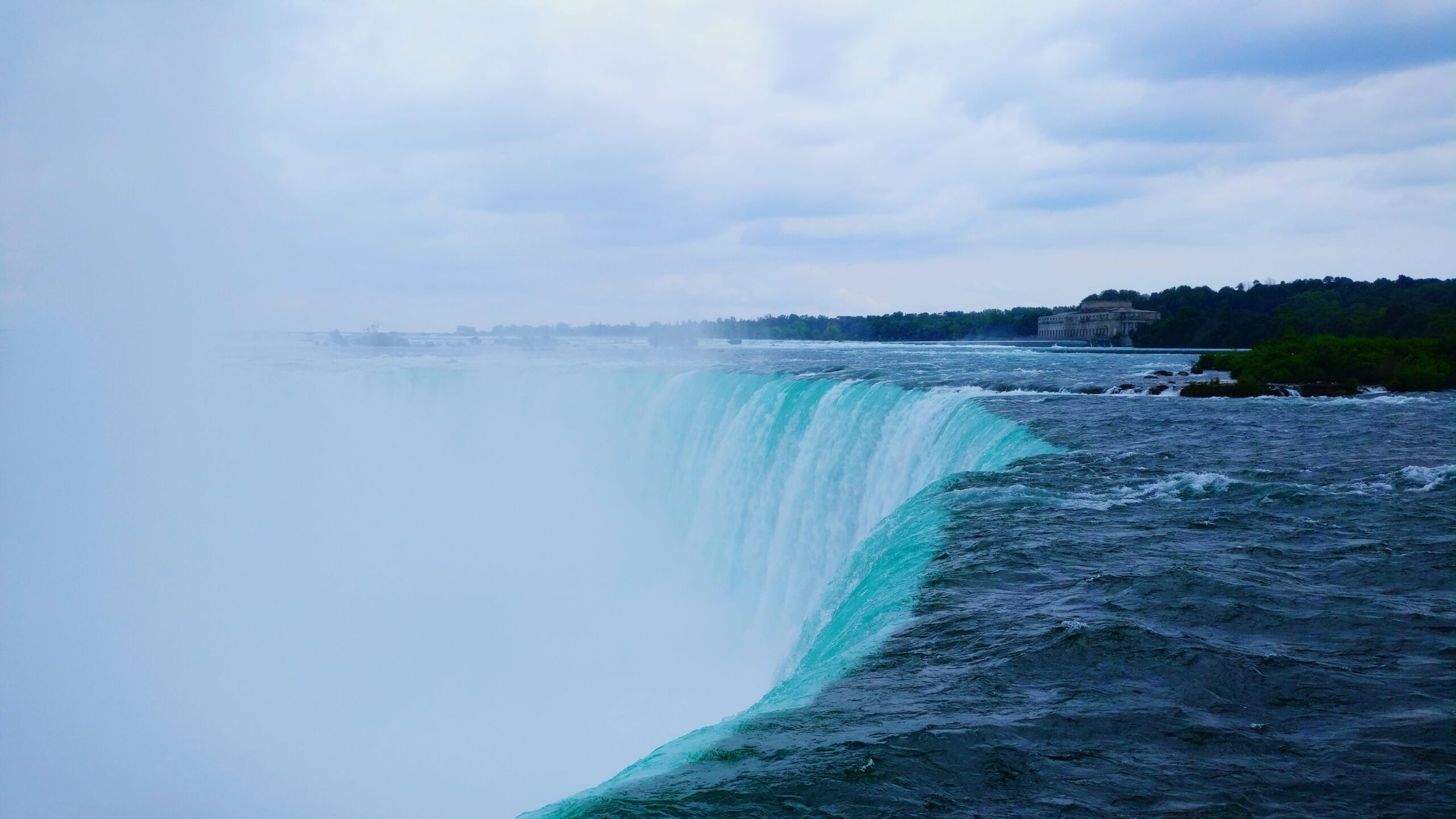 scenic-view-waterfall-against-cloudy-sky